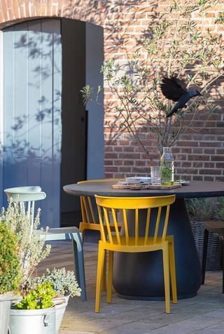 dining set with colourful chairs on a patio