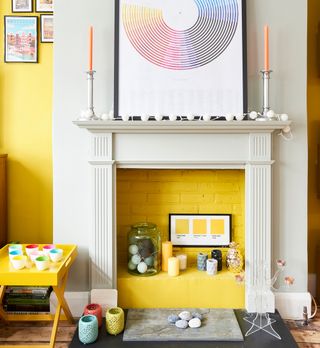 yellow wall empty fireplace with candles