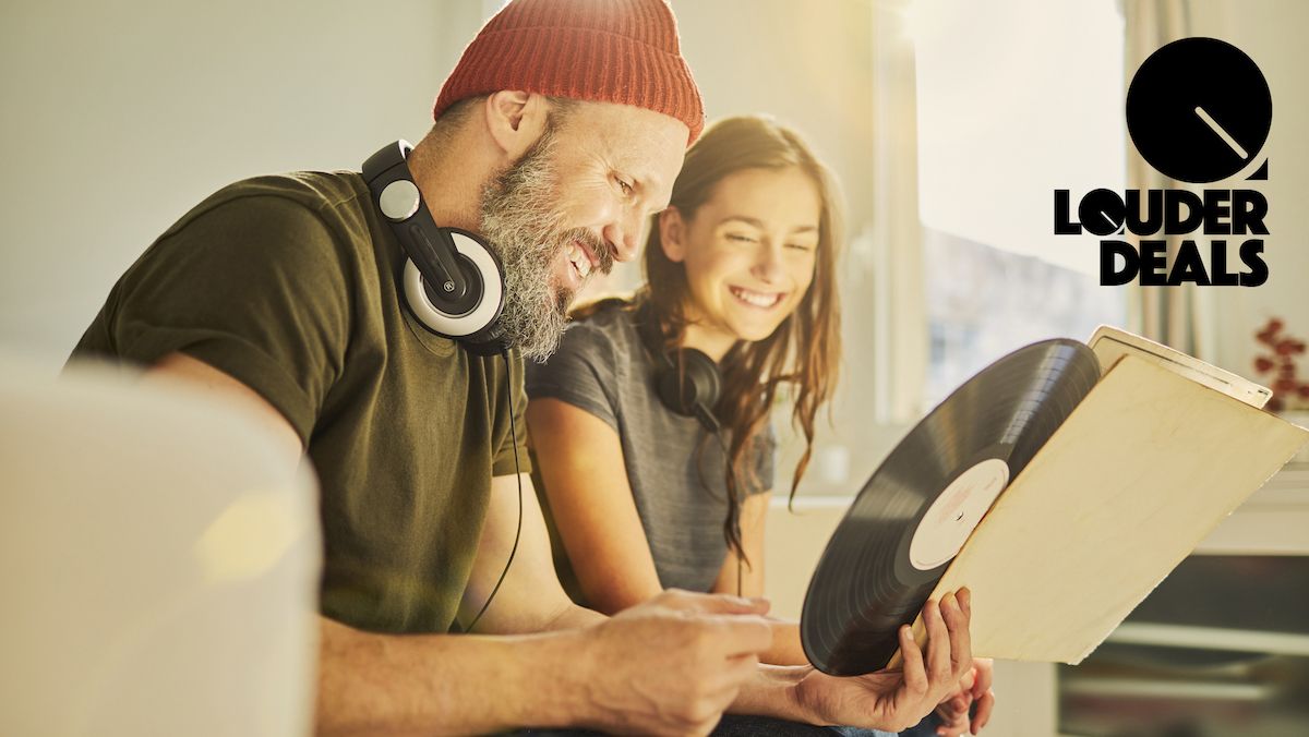 Man and women listening to a vinyl record on a couch