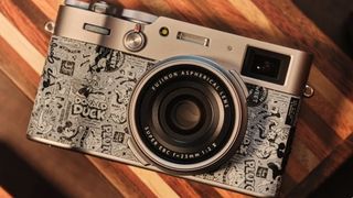 Disney-themed Fujifilm X100V camera on a wooden table