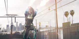 Captain Marvel using her photon blasts atop a moving train