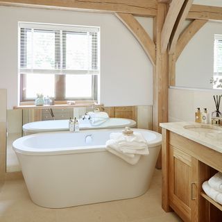 bathroom with bathtub and wooden vanity unit ties