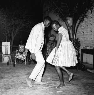 African couple dancing with white