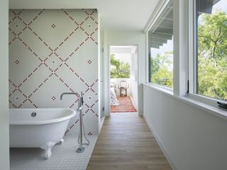 A bathroom segregated within an open plan with tiles