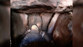 The tomb appears appears to be a "cist" or chamber tomb from the Bronze Age, possibly about 3,000 years old; human bones found inside have been sampled for radiocarbon dating.