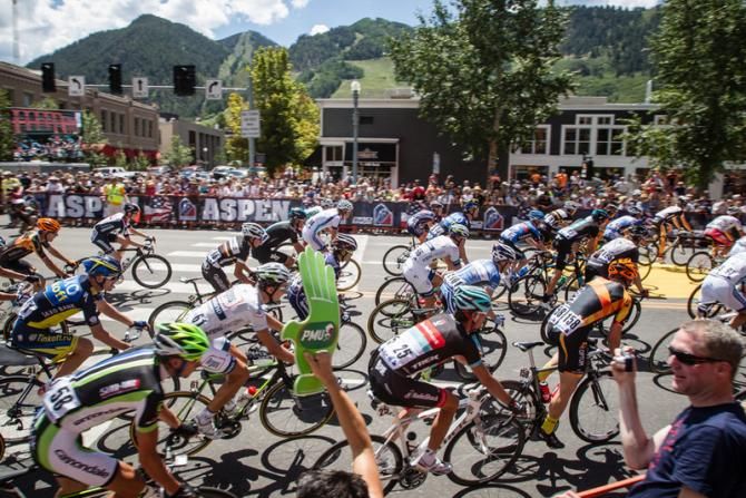 The race heads through town on a neutral start lap.