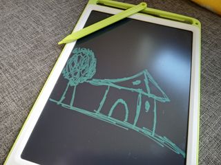 A green and white Richgv LCD Writing Tablet with a green pen