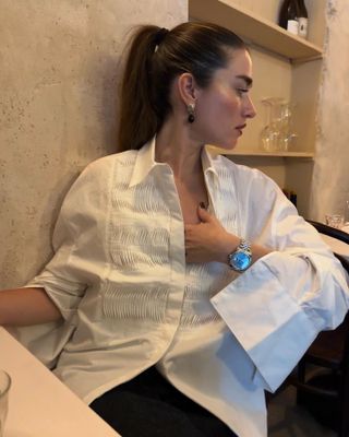 @iliridakrasniqi wearing a white tuxedo shirt and watch