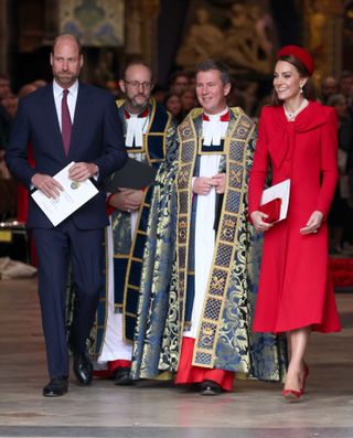 Kate Middleton wearing a red coat walking out of Westminster Abbey with clergy members and Prince William in March 2025