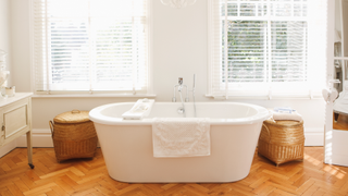 Bathroom with chevron-style oak wooden floor boards