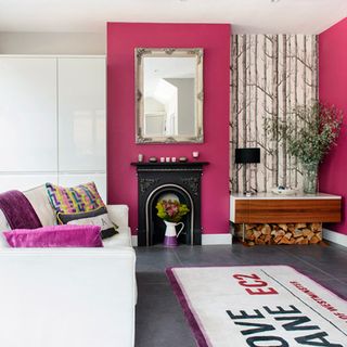 seating area with pink wall and sofa