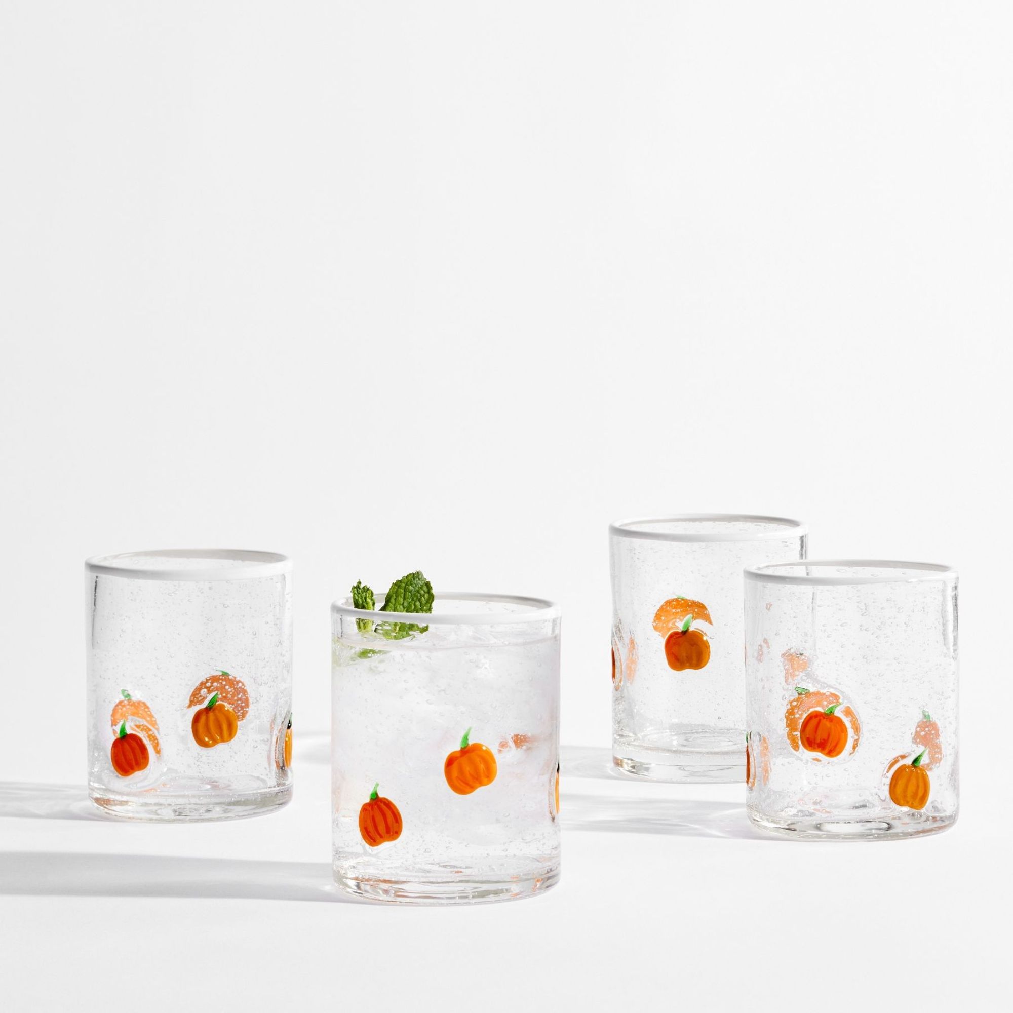 Small glass tumblers with orange pumpkin design