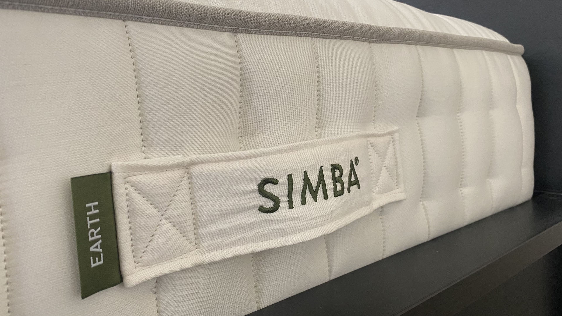A side view of the Simba Earth Escape mattress, including a handle