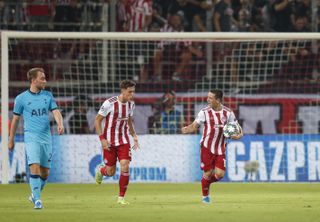 Olympiacos’ Daniel Podence, right, celebrates his goal