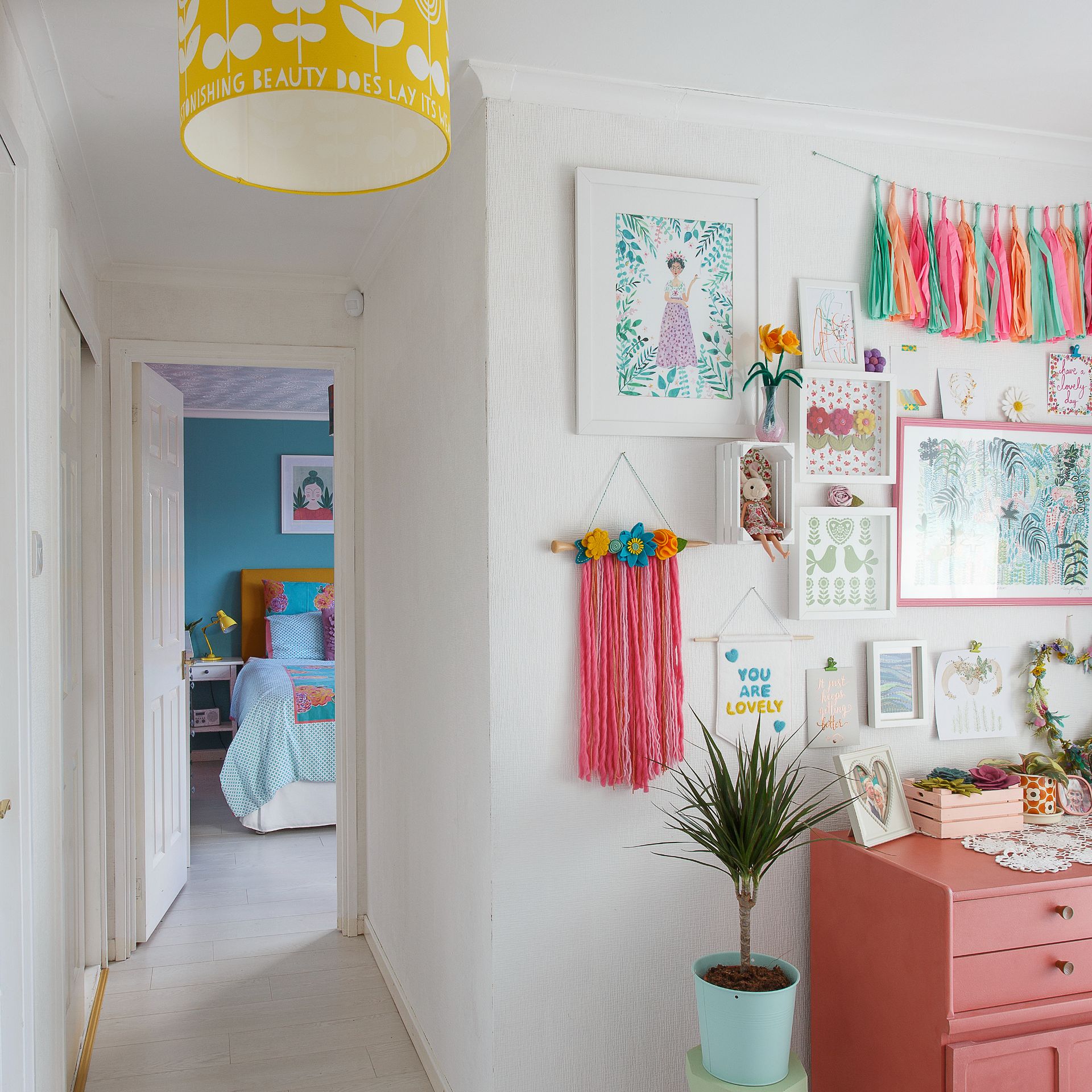 White bedroom wall with fabric wall hangings