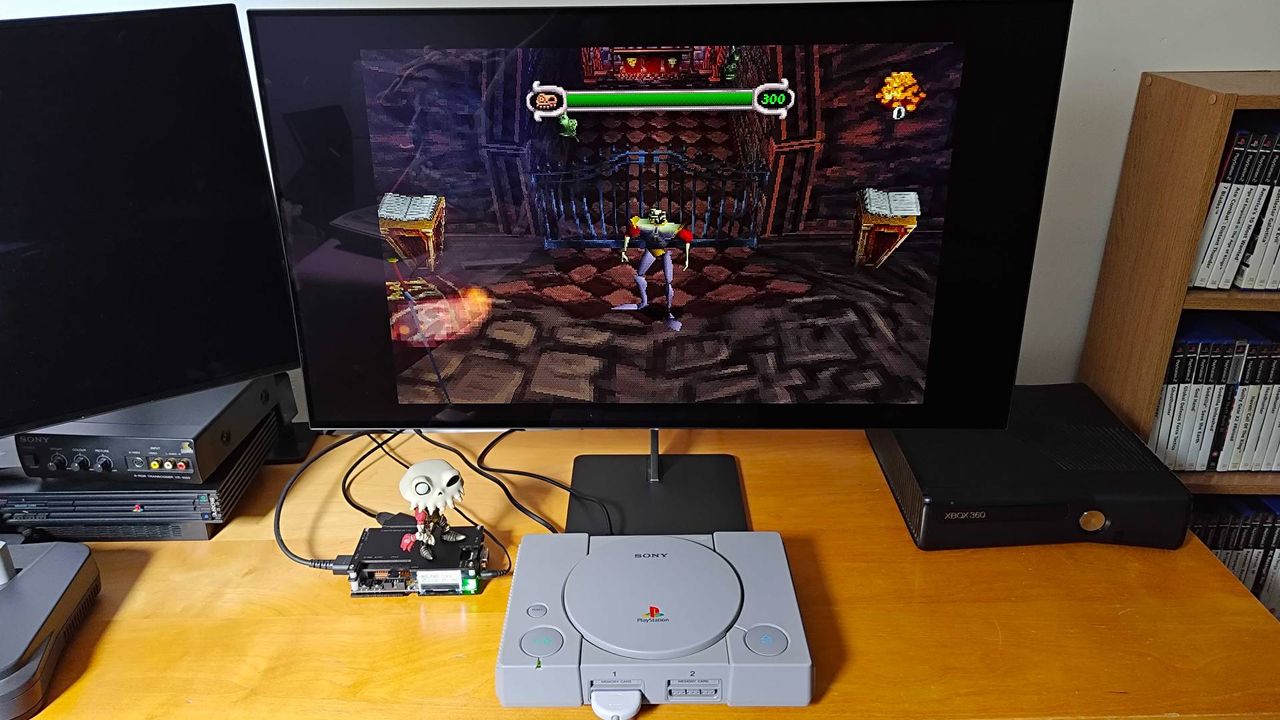 Original PlayStation console connected to Dough Spectrum Black monitor via OSSC upscaler with MediEvil gameplay on screen.