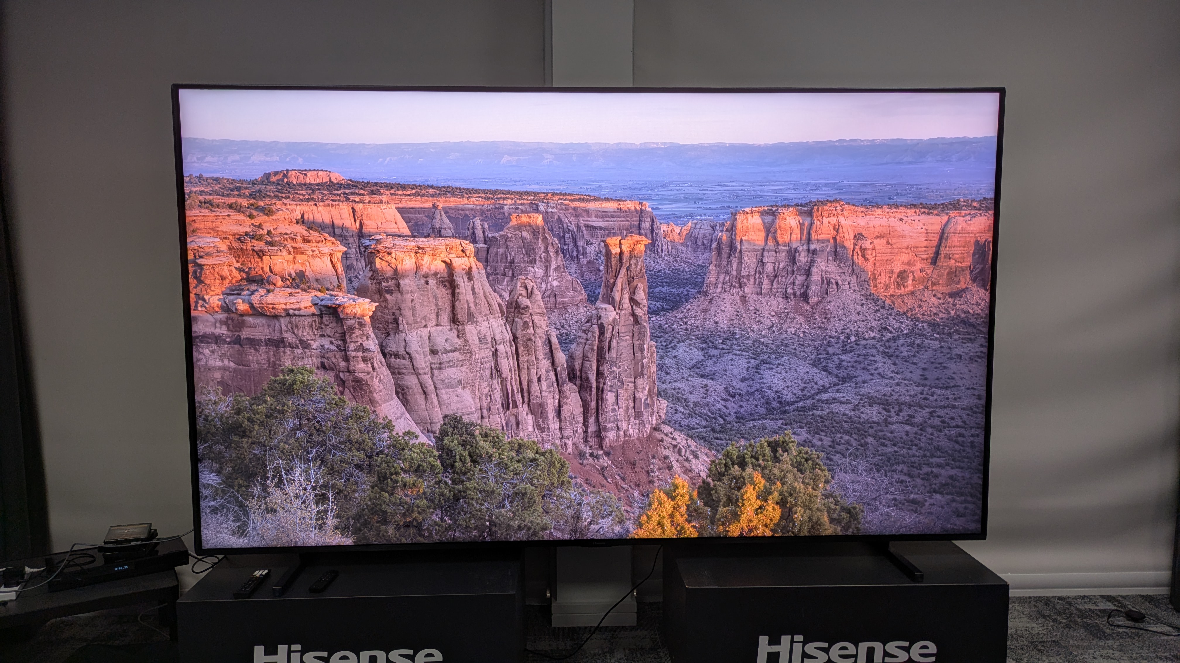 Hisense 116UX RGB mini-LED TV with valley at sunrise on screen