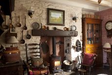 fireplace with welsh spoons in living room with pictures and decorations