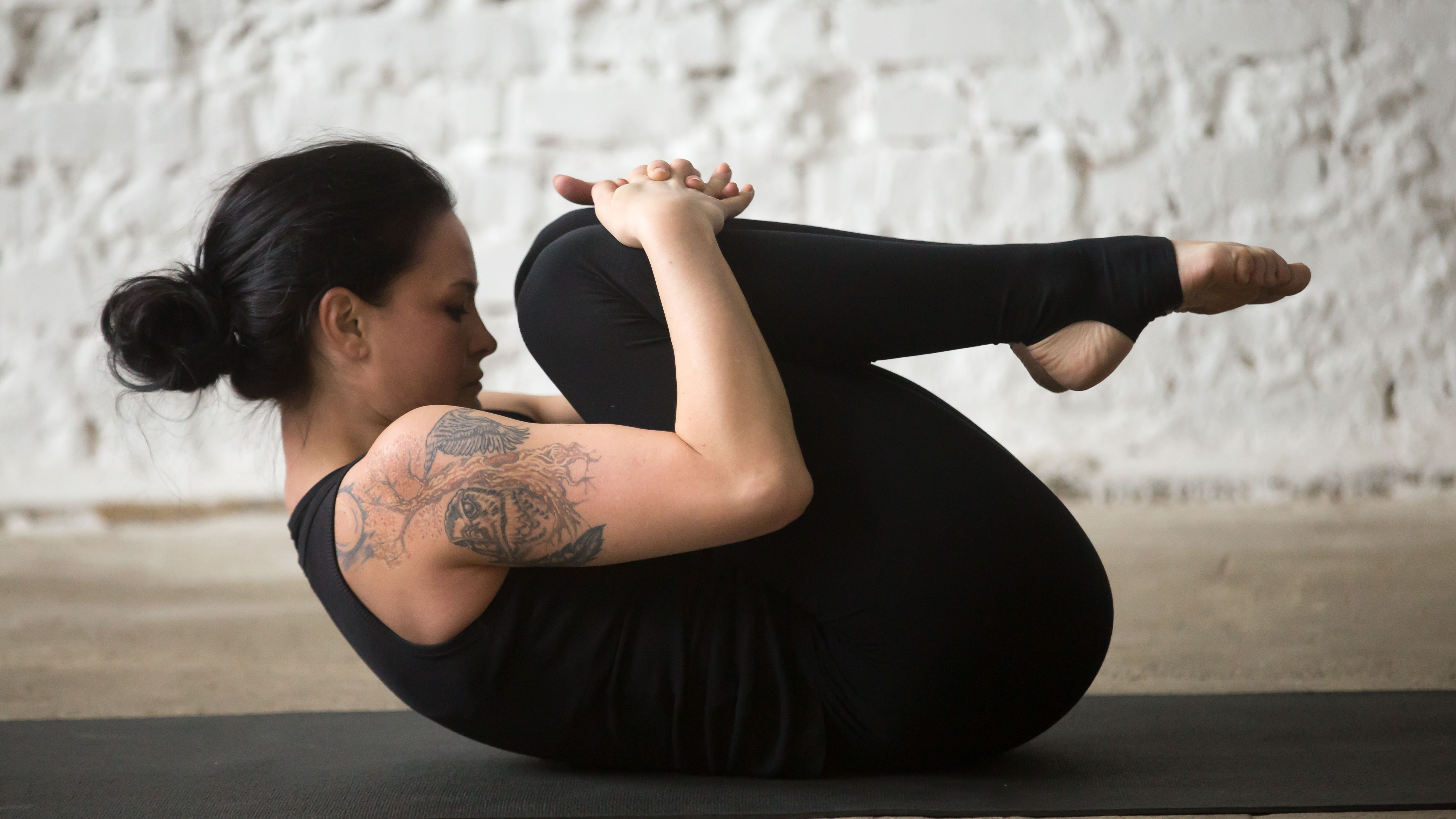 Person doing knees to chest yoga pose