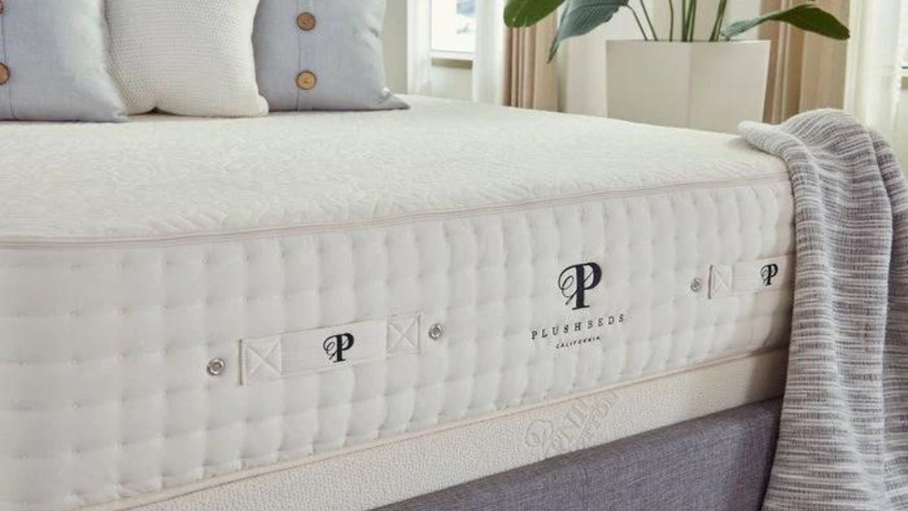 A mattress from one of the best places to buy a mattress, PlushBeds, topped with pillows.