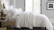 Some of the items in the bedding sales: Boll & Branch sheets and shams on a bed.