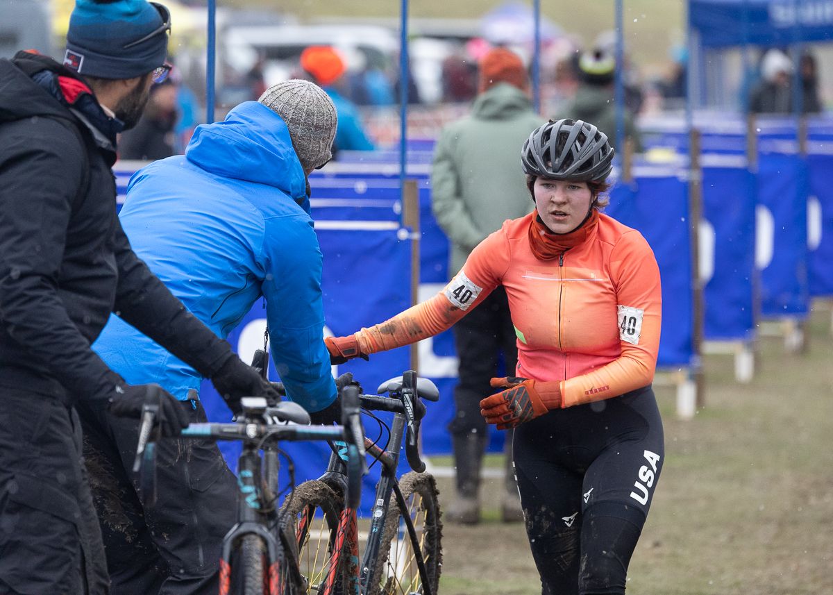 Hannah Dickson makes her way into the pit for a new bike. As the day progressed the course got softer and more muddy creating a hectic day for mechanics and power washers in the pits.