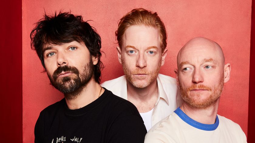 Biffy Clyro looking solemn against a red background