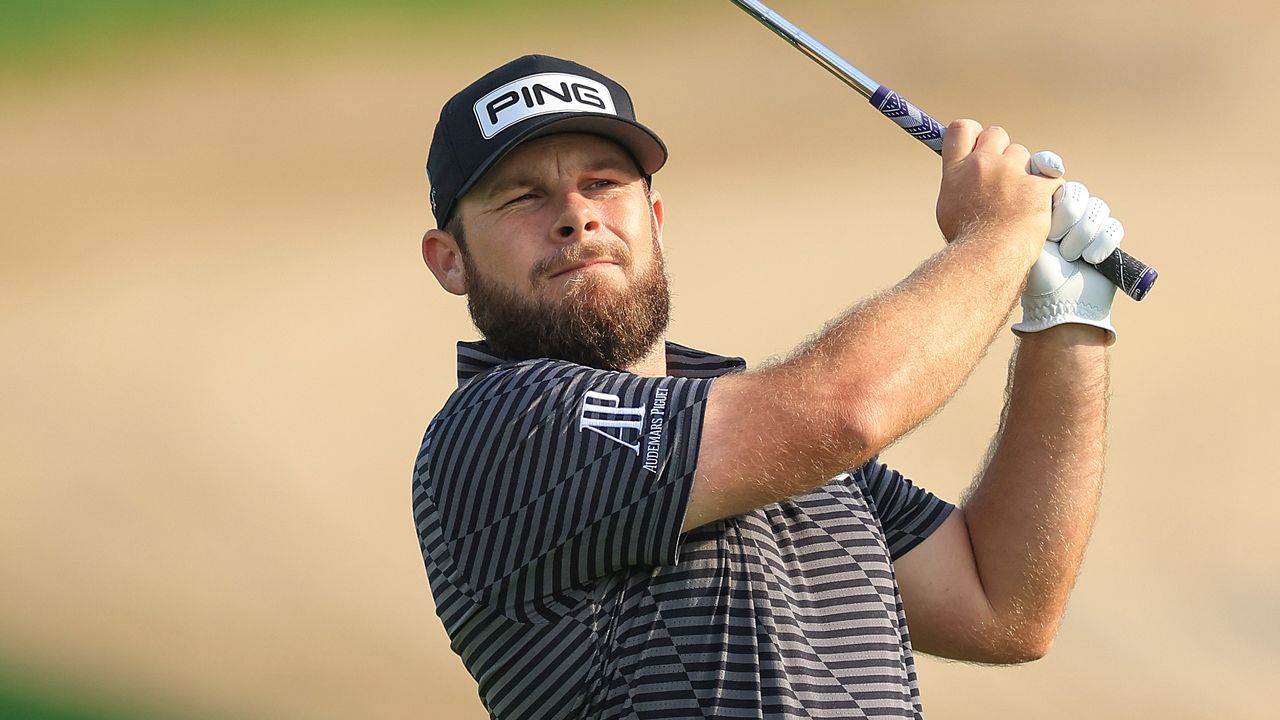 Tyrrell Hatton plays an iron shot during the Dubai Desert Classic