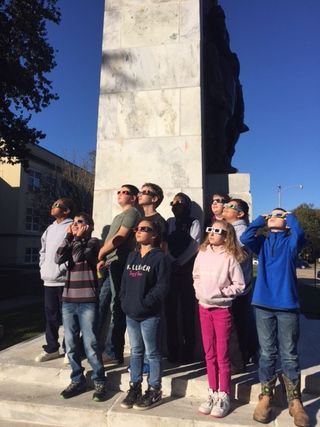 Students in southern Illinois observe the sun with solar viewing glasses, ahead of the total solar eclipse that will cross this part of the country on Aug. 21, 2017