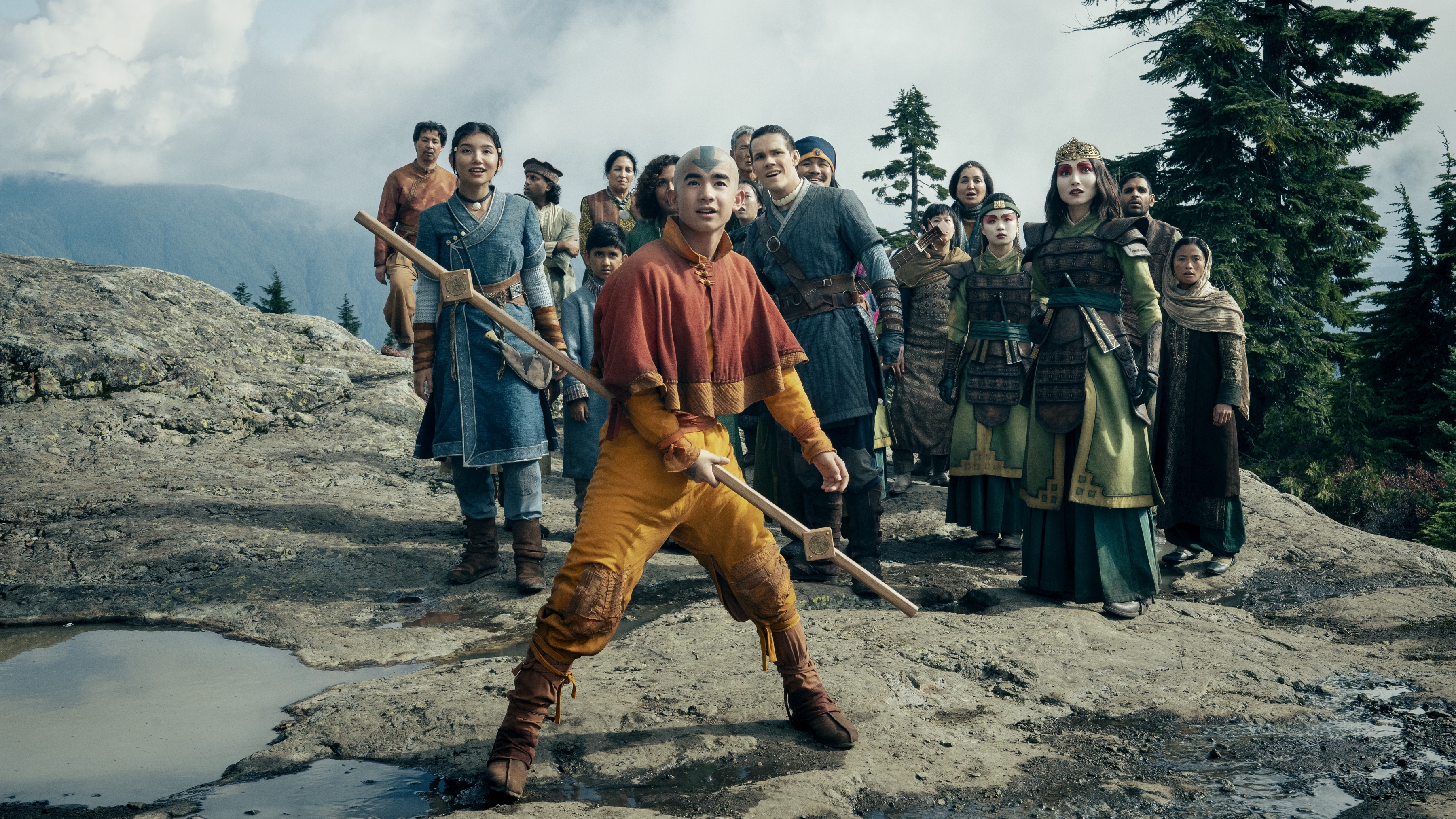 (L to R) Kiawentiio Tarbell as Katara, Gordan Cormier as Aang, Ian Ousley as Sokka, Maria Zhang as Suki in season 2 of Avatar: The Last Airbender looking up at something in awe.