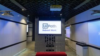 A room with a tv in the centre with the words UiPath displayed on screen