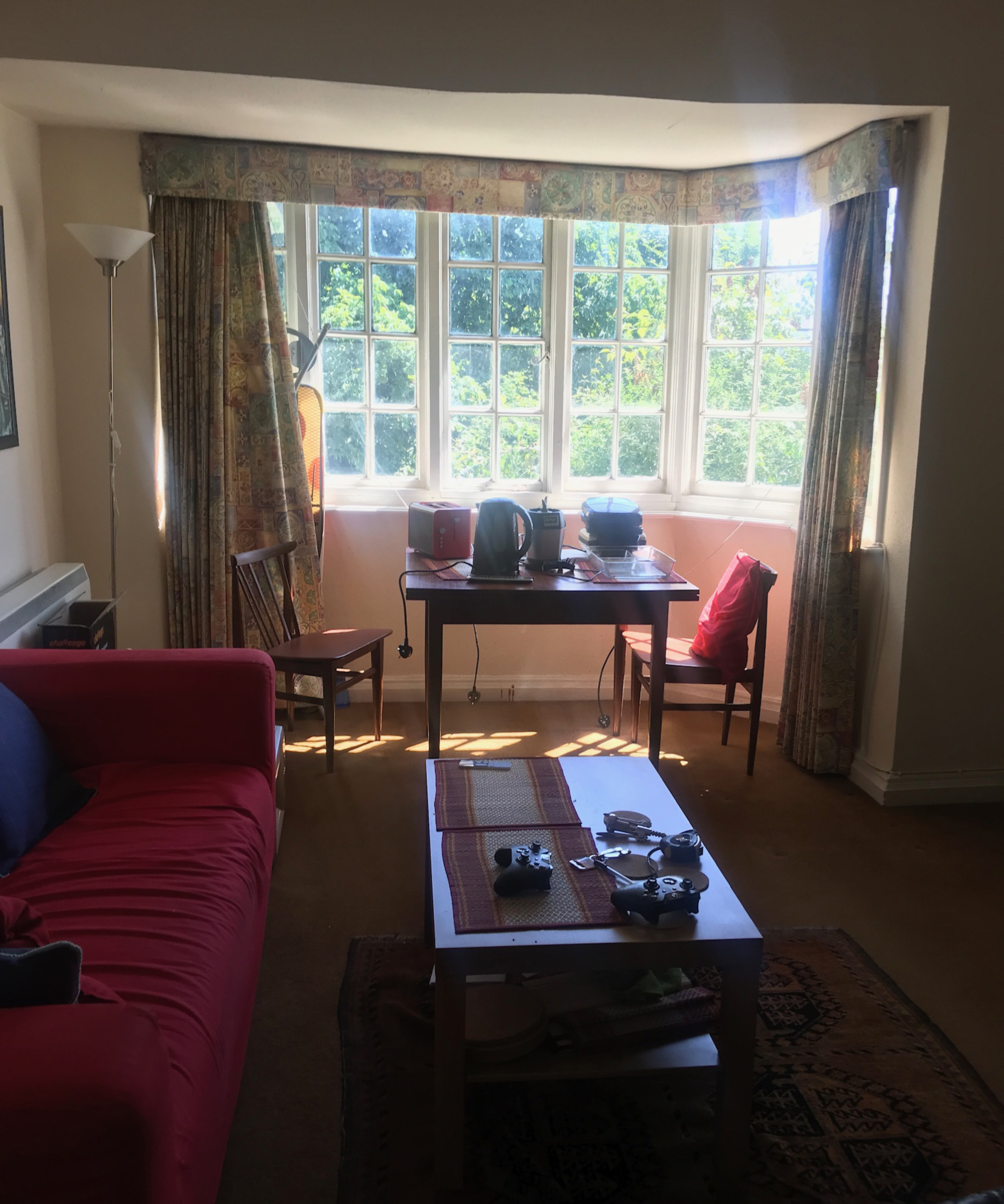 A light-filled old-fashioned living room in need of a makeover