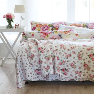 bedroom with white wall and floral bed