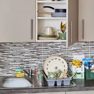 Kitchen with tiled spashback, sink, cupboard