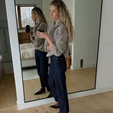 European in a half-zip sweater and jeans