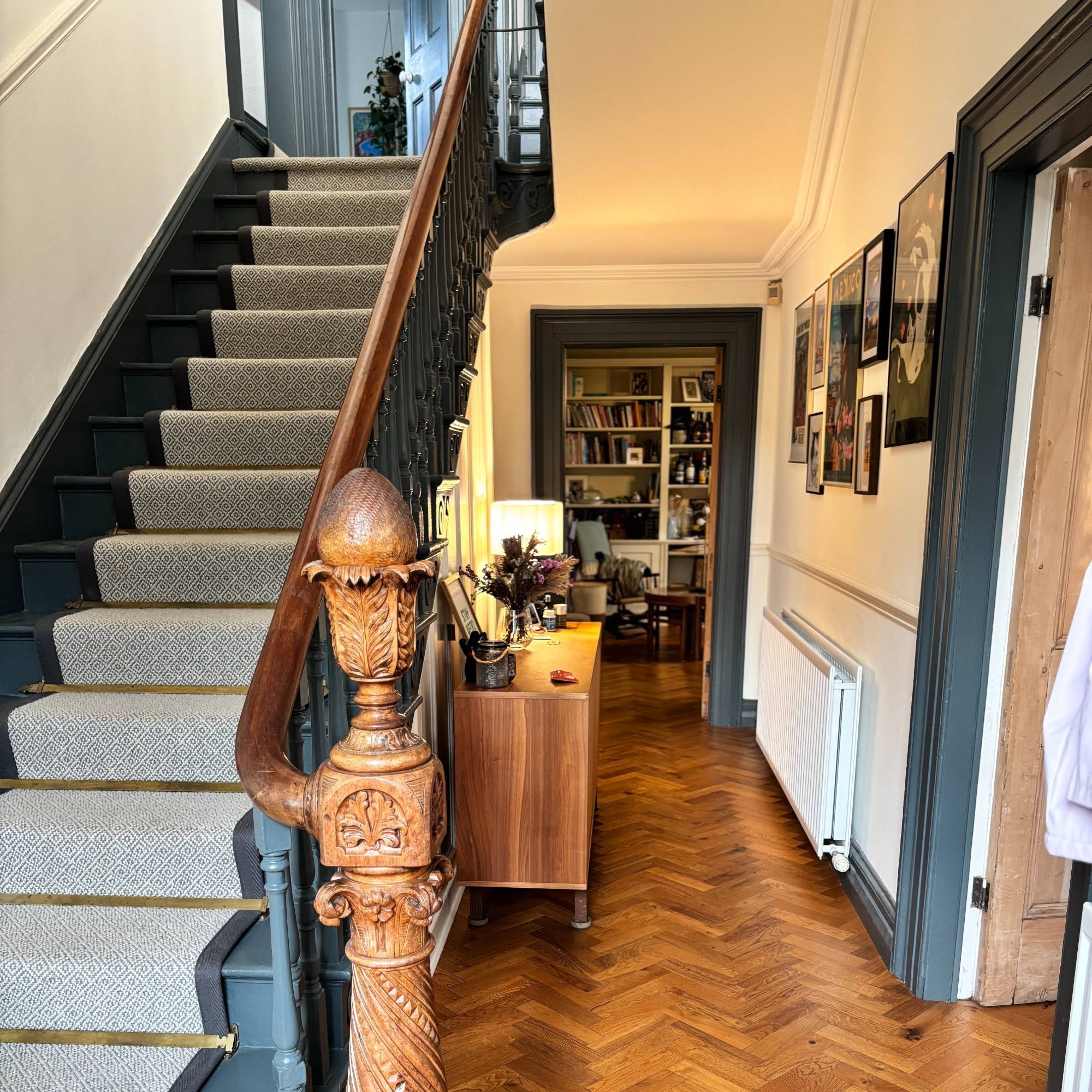 Jenny McFarlane's hallway painted in Farrow &amp;amp; Ball's All White with contrasting door frames and stairs