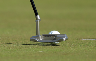 A close up of Collin Morikawa's Olson blade putter