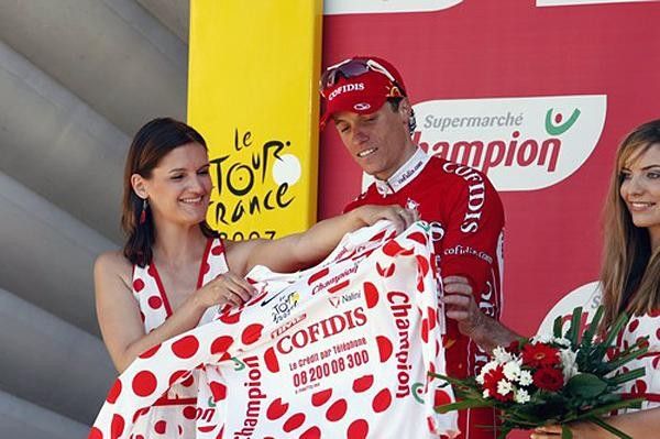 Chavanel gets help to put on another red-dotted jersey.