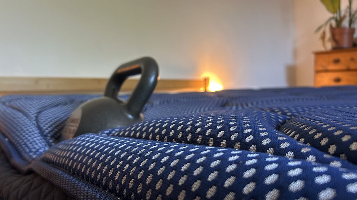 A weight resting on the edge of the DreamCloud Luxe Memory Foam mattress to measure edge support