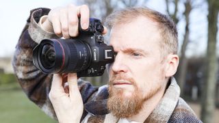 Canon RF 14mm F1.4L VCM lens in photographer Tim Coleman's hands, attached to an EOS R5 mark II