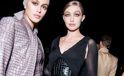Kaia Gerber and Gigi Hadid wear purple jacket and black dress at Tom Ford S/S 2019