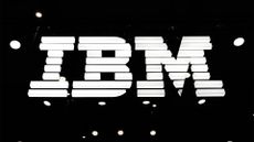 IBM logo illuminated in white against a black background at the company's exhibitor stall at Mobile World Congress 2025. 