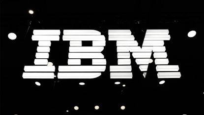 IBM logo illuminated in white against a black background at the company's exhibitor stall at Mobile World Congress 2025.