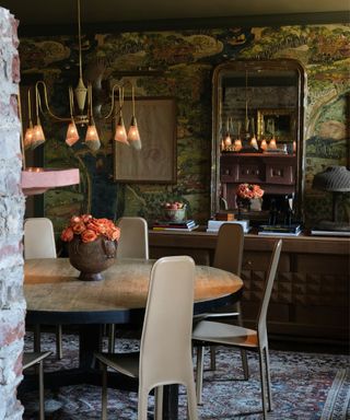 maximalist dining room with wallpaper and layered art and textures