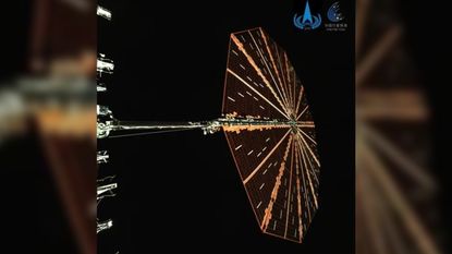 A photo of a circular solar panel in space. This is the first photo of the Tianwen2 spacecraft.