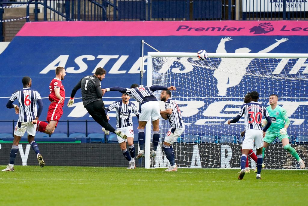 Liverpool's Brazilian goalkeeper Alisson Becker celebrates scoring his team's second goal with teammates during the English Premier League football match between West Bromwich Albion and Liverpool at The Hawthorns stadium in West Bromwich, central England, on May 16, 2021. - - RESTRICTED TO EDITORIAL USE. No use with unauthorized audio, video, data, fixture lists, club/league logos or 'live' services. Online in-match use limited to 120 images. An additional 40 images may be used in extra time. No video emulation. Social media in-match use limited to 120 images. An additional 40 images may be used in extra time. No use in betting publications, games or single club/league/player publications. (Photo by Tim Keeton / POOL / AFP) / RESTRICTED TO EDITORIAL USE. No use with unauthorized audio, video, data, fixture lists, club/league logos or 'live' services. Online in-match use limited to 120 images. An additional 40 images may be used in extra time. No video emulation. Social media in-match use limited to 120 images. An additional 40 images may be used in extra time. No use in betting publications, games or single club/league/player publications. / RESTRICTED TO EDITORIAL USE. No use with unauthorized audio, video, data, fixture lists, club/league logos or 'live' services. Online in-match use limited to 120 images. An additional 40 images may be used in extra time. No video emulation. Social media in-match use limited to 120 images. An additional 40 images may be used in extra time. No use in betting publications, games or single club/league/player publications. (Photo by TIM KEETON/POOL/AFP via Getty Images)