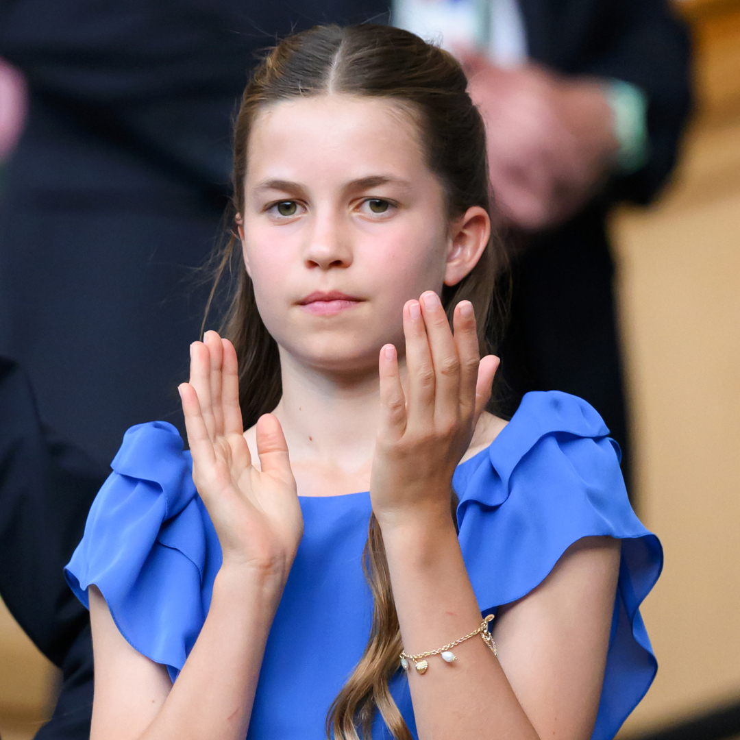 Princess Charlotte clapping in a blue dress