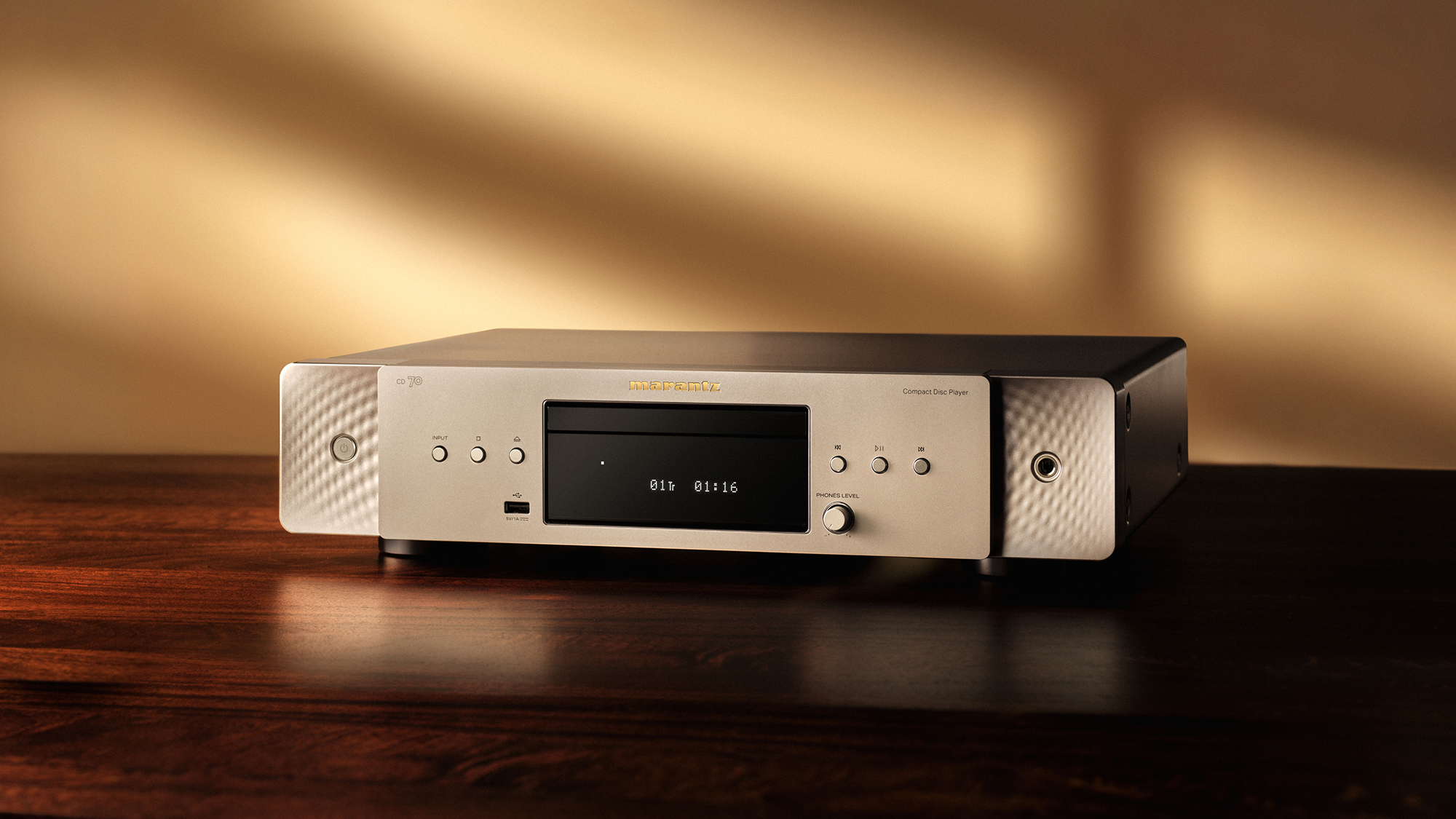 Marantz CD 70 in silver/gold on a red tabletop with a shadow in the background