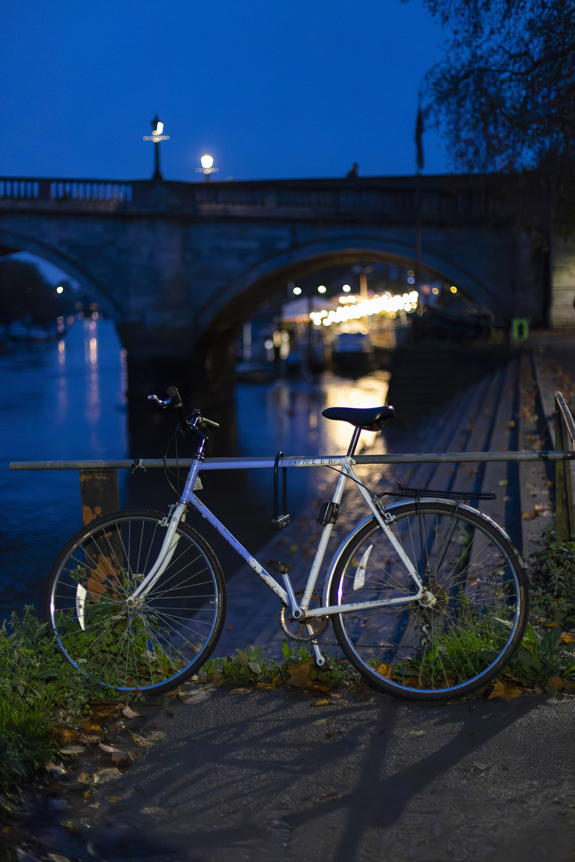 A low light scene of a river at night showing the difference between examples using AI Denoise