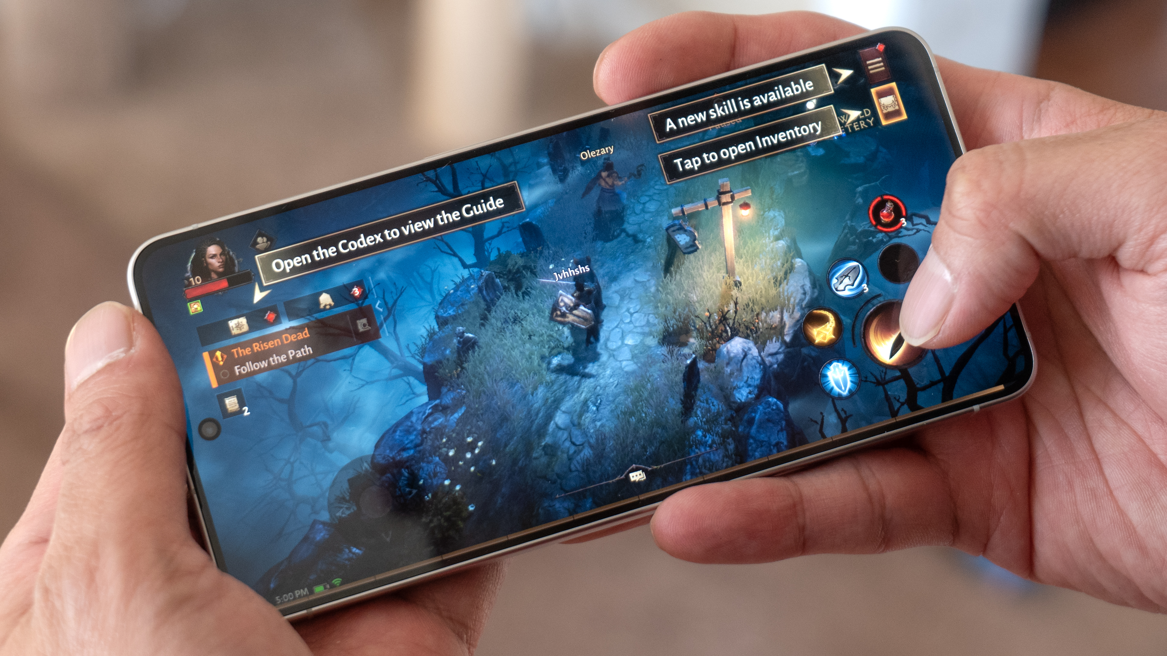 Samsung Galaxy S26 held in the hand running Diablo Immortal.